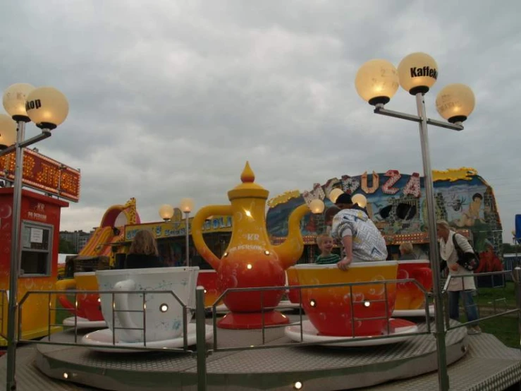 two people stand near tea set at the fair