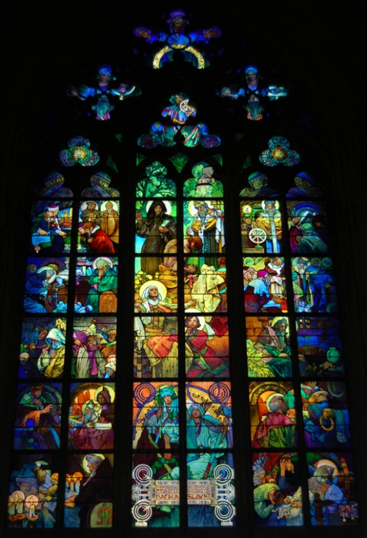 a very large stain glass window with many religious items