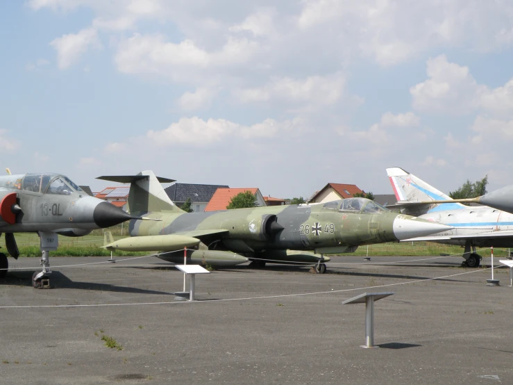 jets sit on the runway at a small airfield