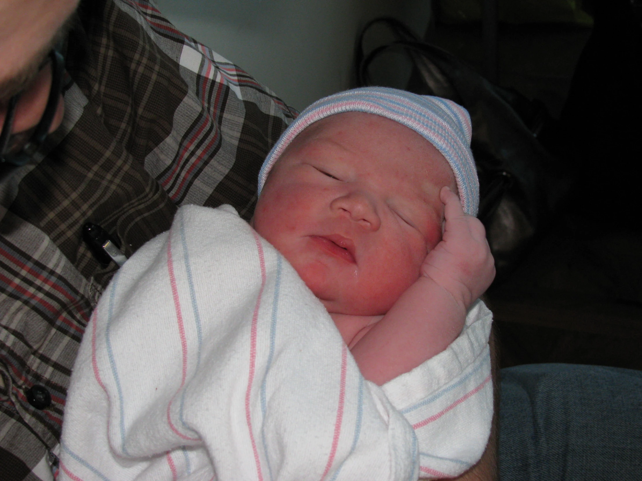 a baby is asleep in his hands with its head hanging over