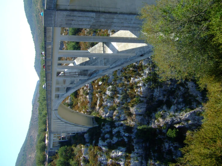 an elevated pedestrian bridge near some trees and buildings