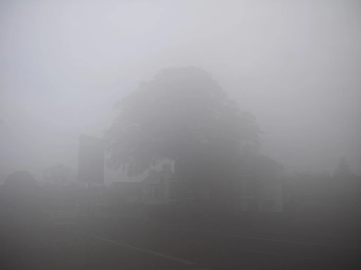 the fog is covering a small town in the day