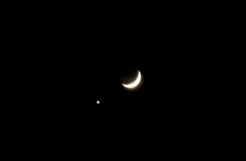 two partial phases of the moon on black background