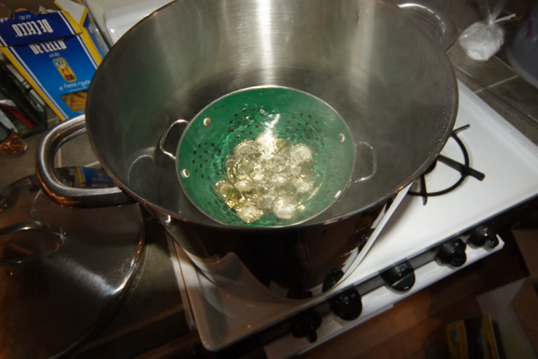 a green bowl sitting on top of a stove top