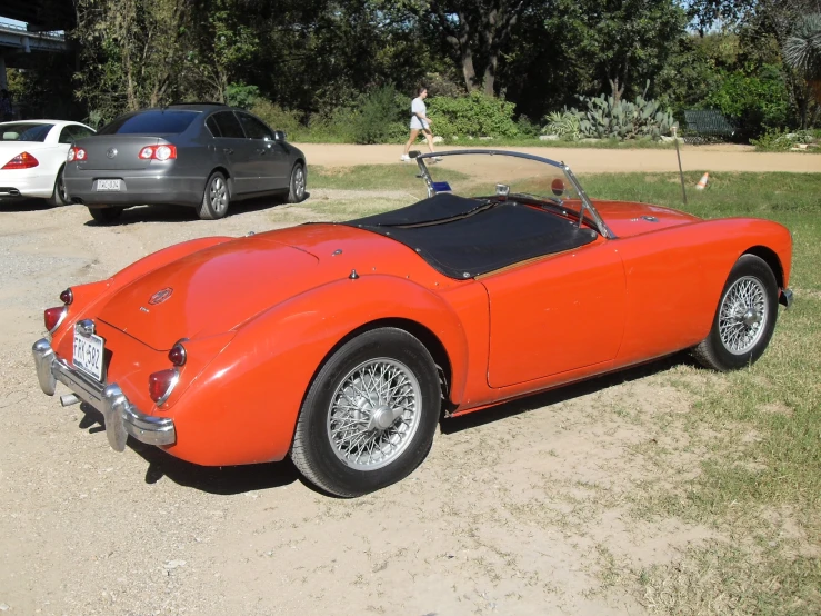 an orange sports car sitting in a parking lot