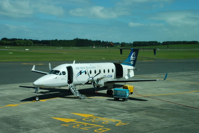 a small plane parked on the runway at an airport