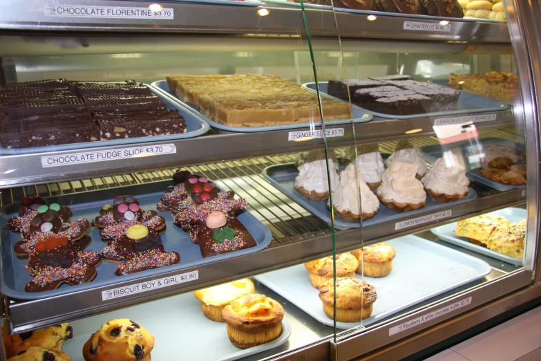 the shelf contains a number of different baked goods