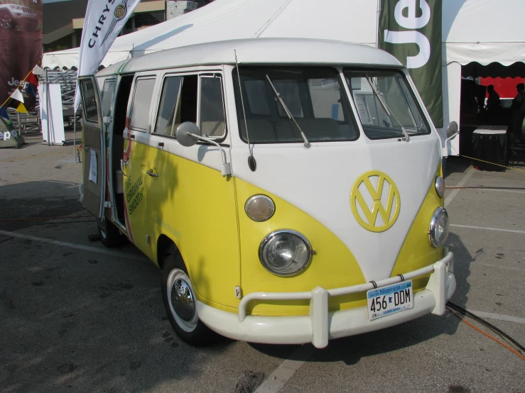 this yellow and white van has the vw logo