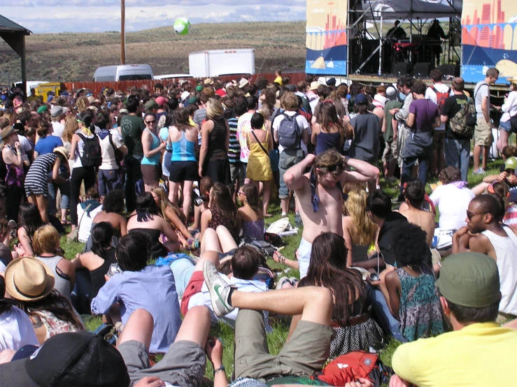 a crowd of people with their hands up