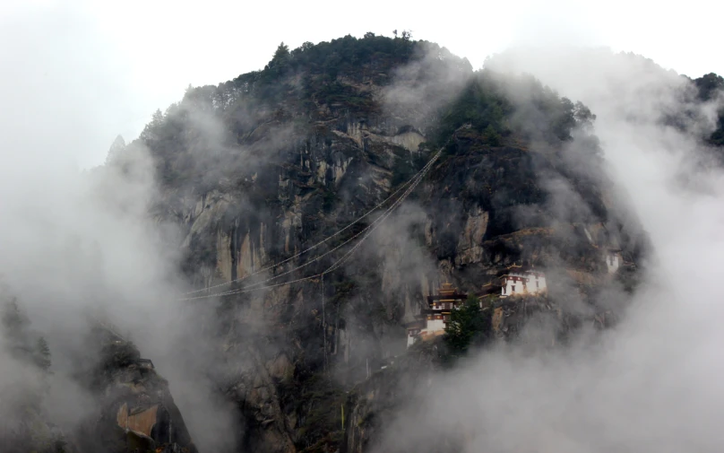 a view of a large mountain with a cloud layer below it