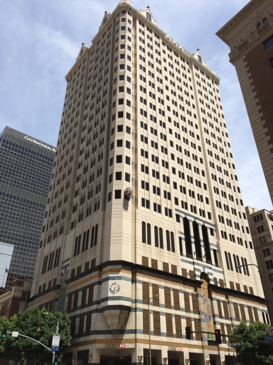 a large beige building is shown under a cloudy sky