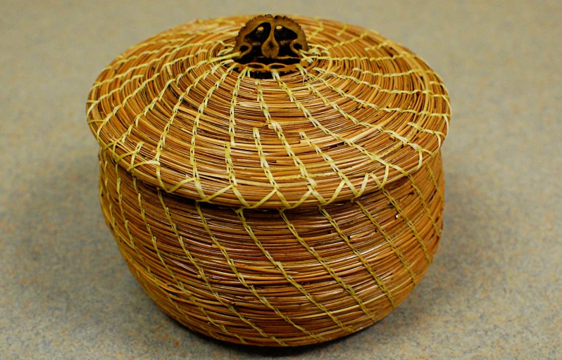 a decorative brown canister sitting on a surface