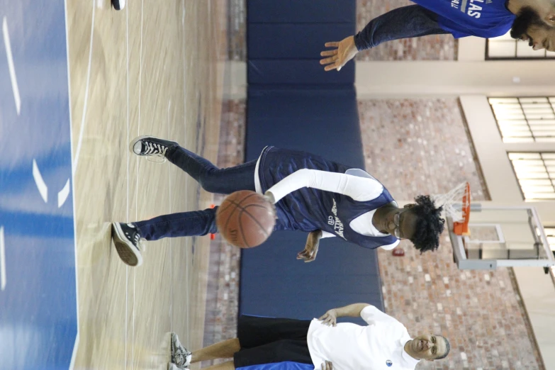 two people playing basketball on a basketball court