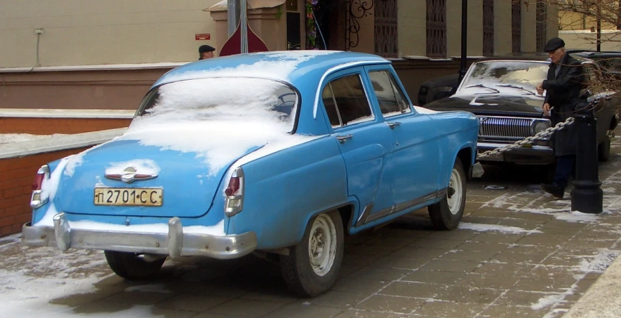 an old car is being towed down the street