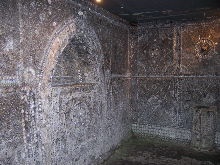 a room in the bat with intricately painted stone carvings