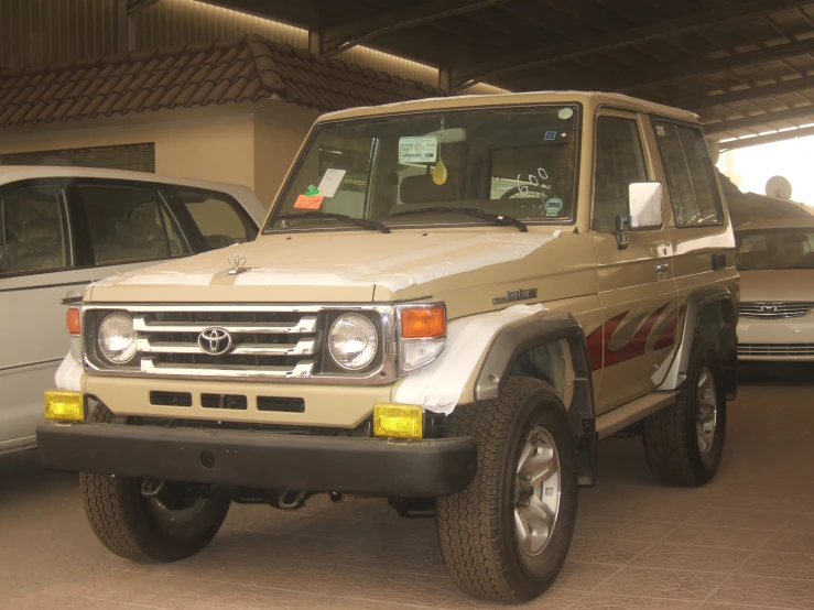 an older toyota pickup van parked inside a garage