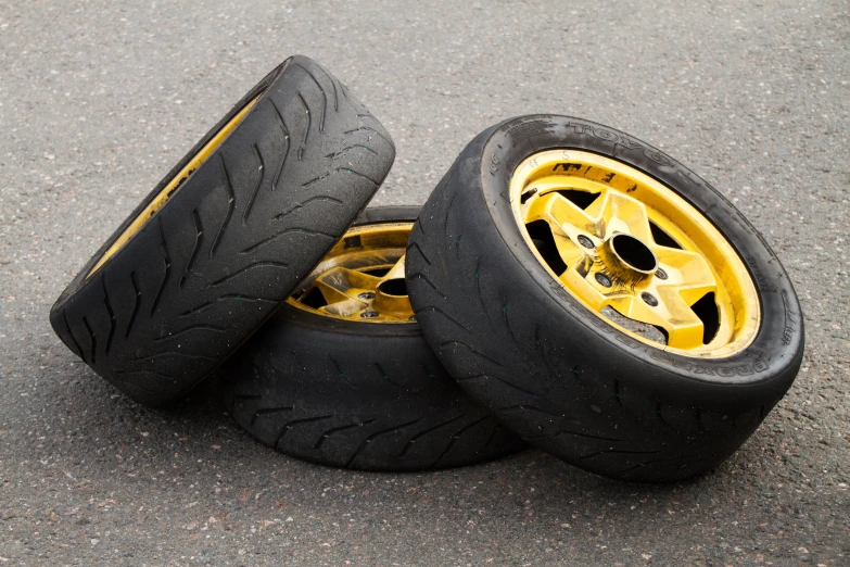 two pieces of yellow tires on the asphalt