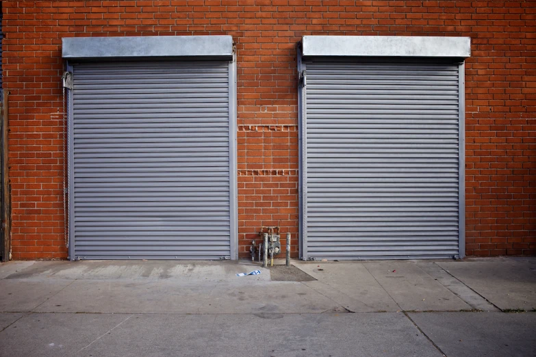 two closed metal roller shutters on the wall