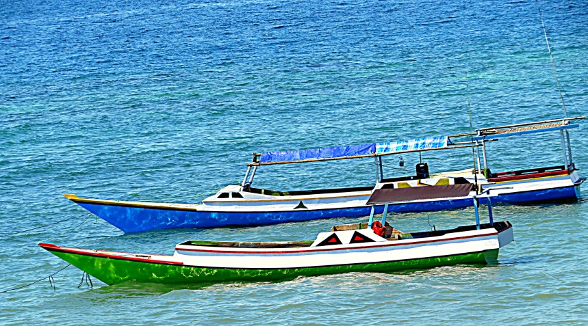 two small boats are floating on the water