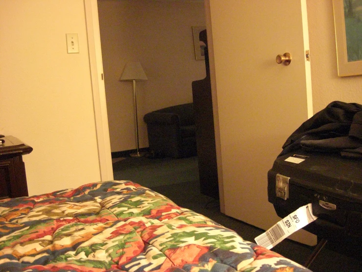 a black suitcase sitting next to a bed