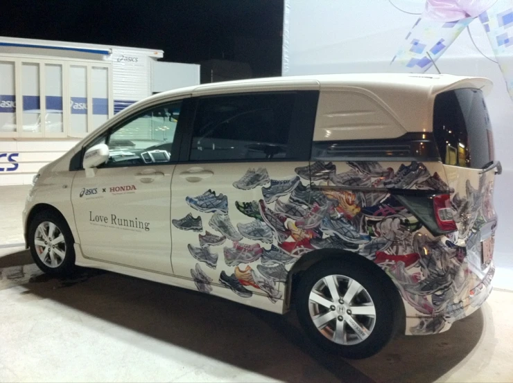 a white car is sitting on display in a room