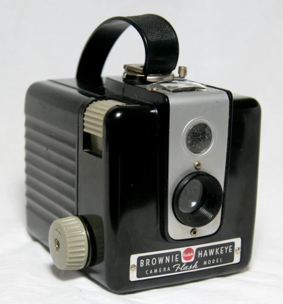 an old fashioned portable camera on white surface