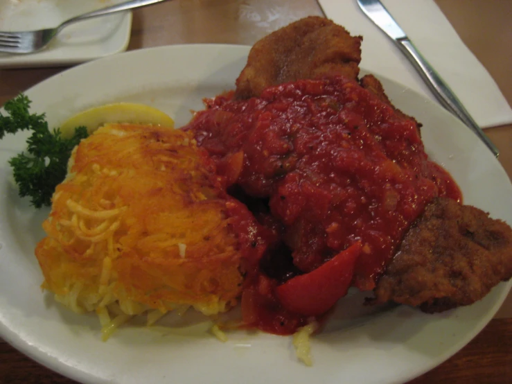 a plate topped with meat, spaghetti and pasta