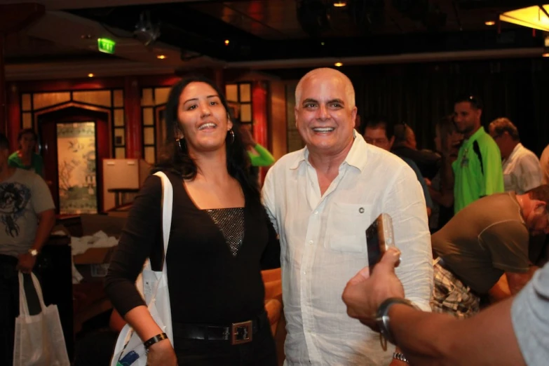 two people standing in a room holding drinks