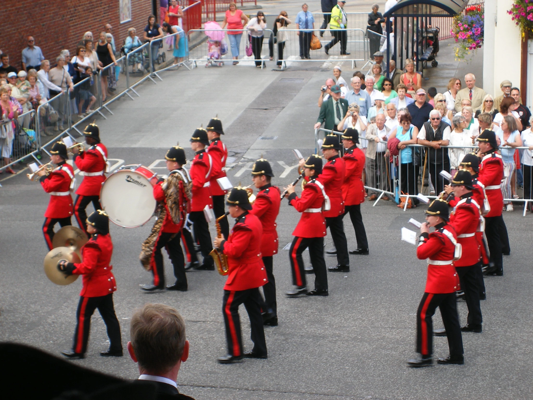 the band is marching along the street in a parade