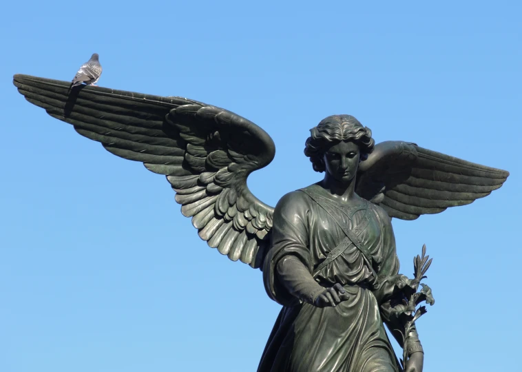 a statue with some kind of bird perched on top