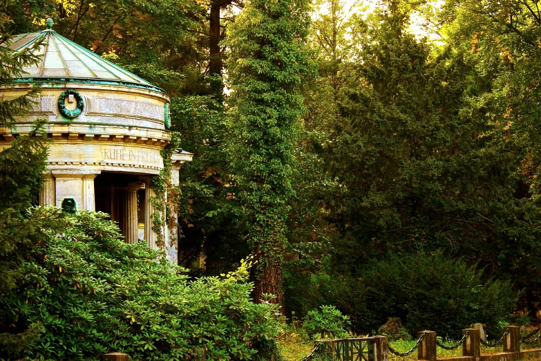 an old stone water tower near some trees