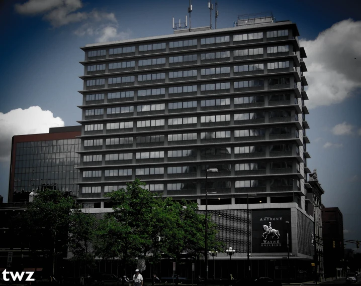 a high rise office building under cloudy sky