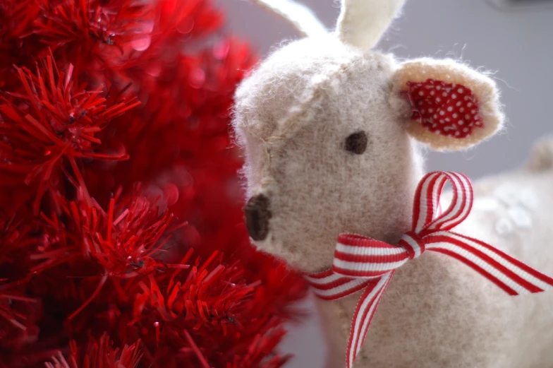 a stuffed animal next to a christmas tree