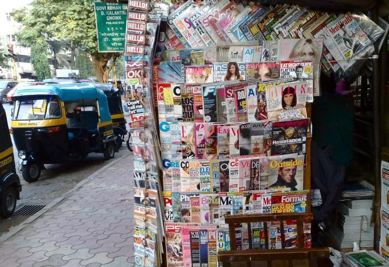 a large newspaper stand on the street side