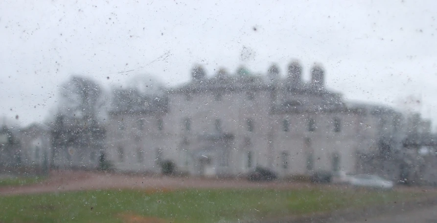 the view of a huge mansion across a windshield