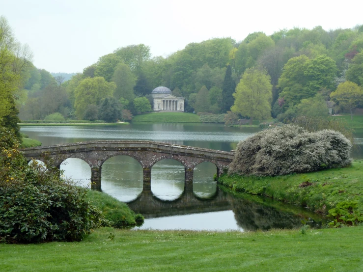 a bridge with a small building in the background