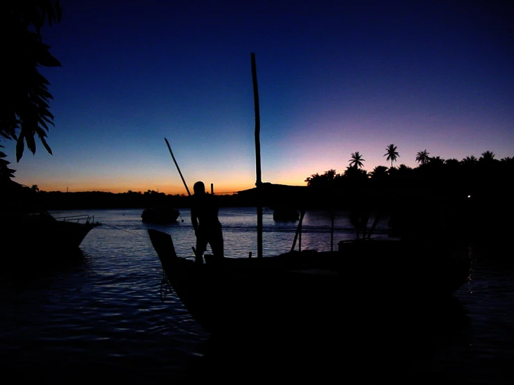 a person standing on the front of a boat