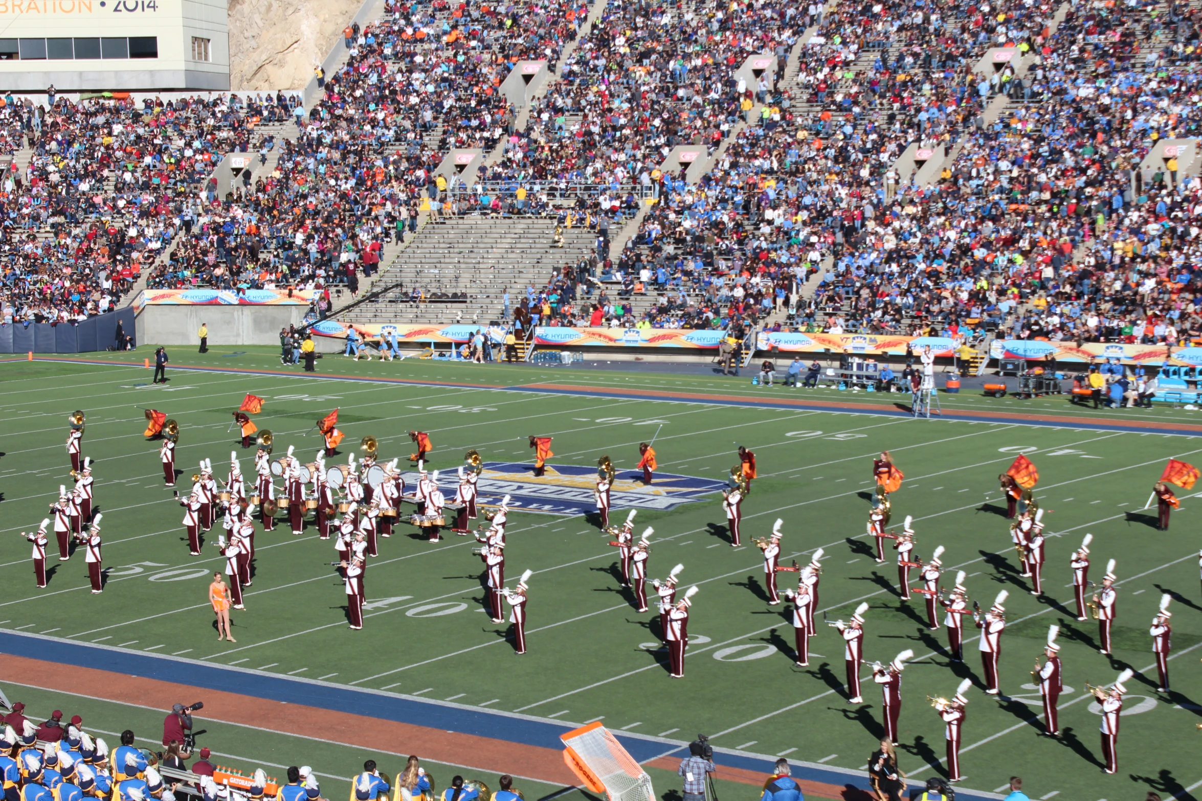 a group of marching players standing on top of a football field