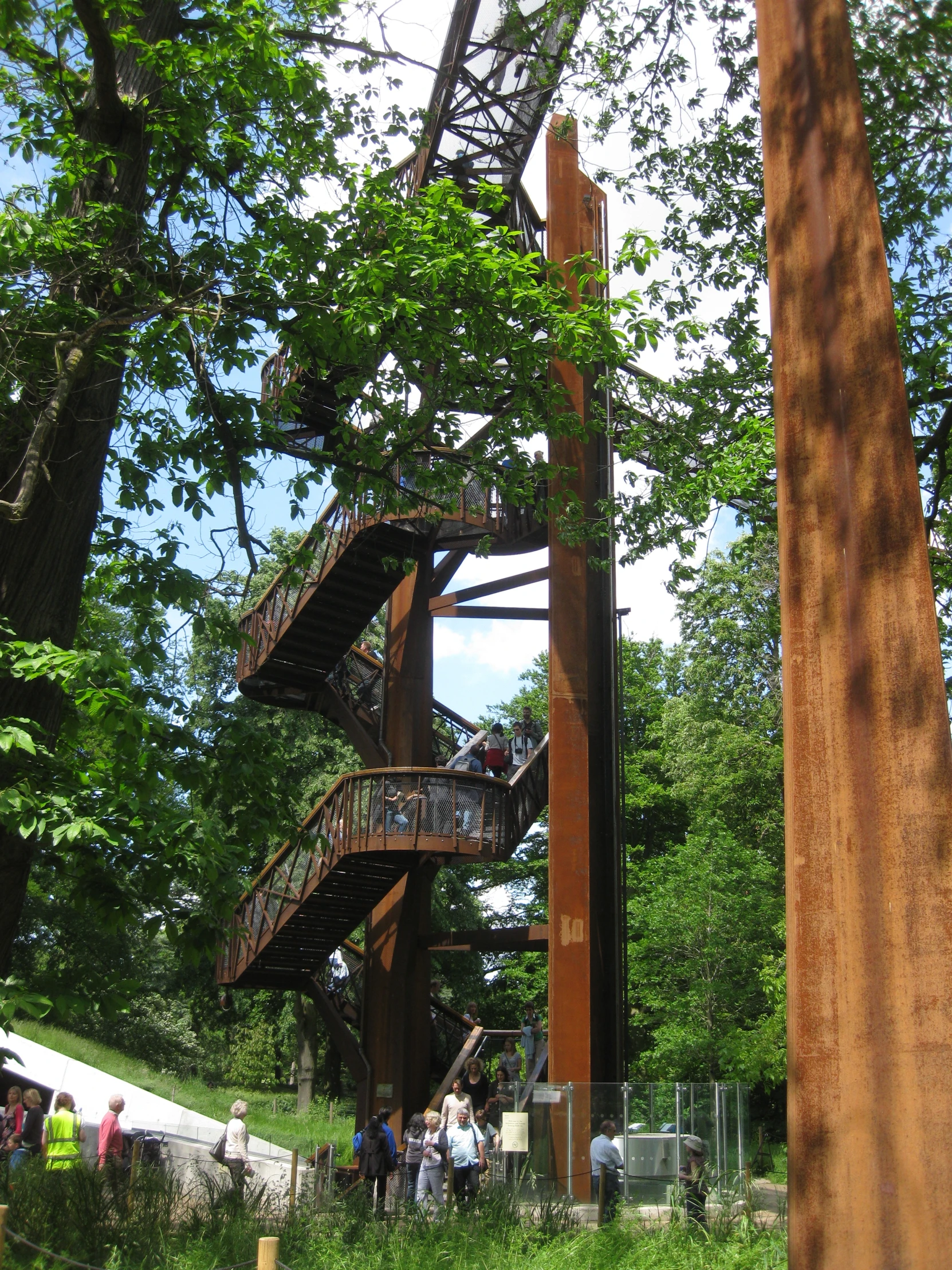 an old structure with a spiral staircase next to trees