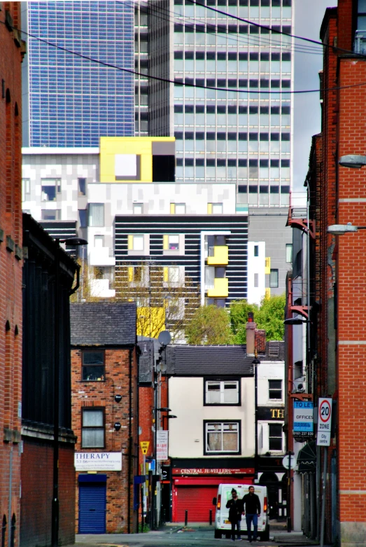 people stand in the middle of a narrow alleyway