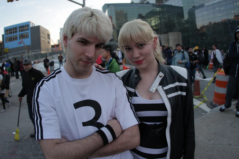 a man with blonde hair and a blond girl standing next to each other