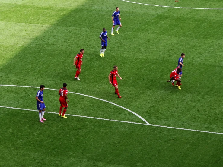 a group of men standing on top of a soccer field