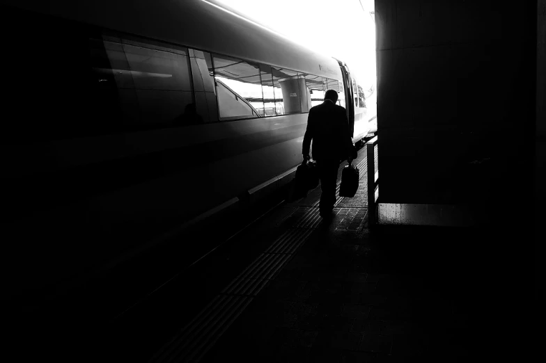 a black and white po with a person standing next to a train