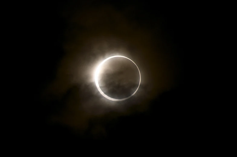 a black and white po with a small partial eclipse