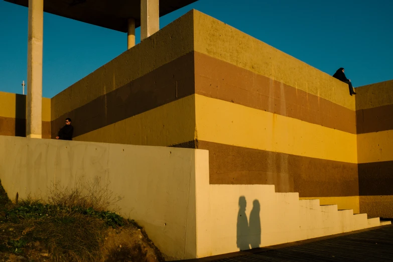 a person standing on stairs next to a building