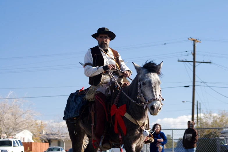 a man riding on the back of a horse in the middle of town