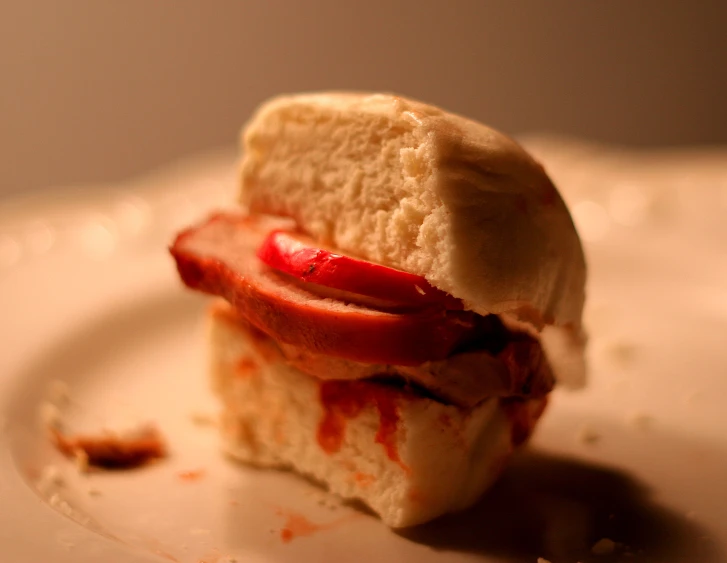 sandwich that has been covered in melted sauce on a plate