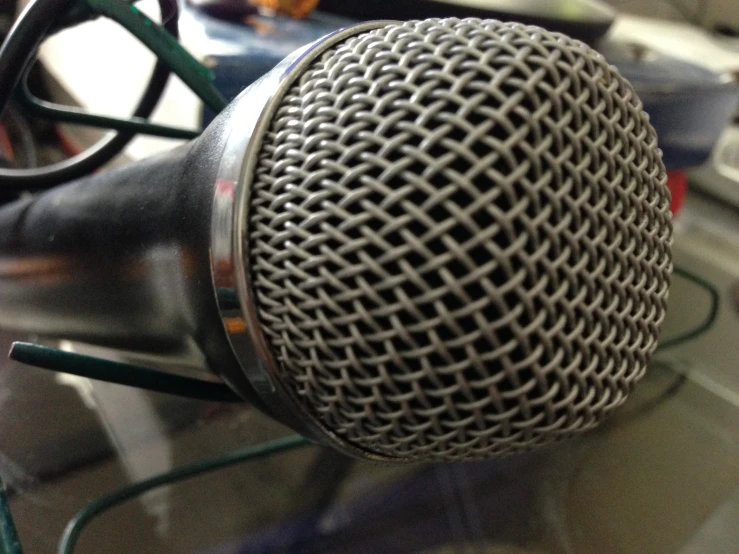 a close up of a microphone with wires in the background