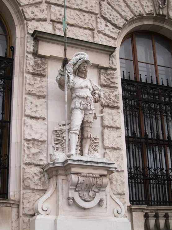 a statue on the corner of a building in an old european town