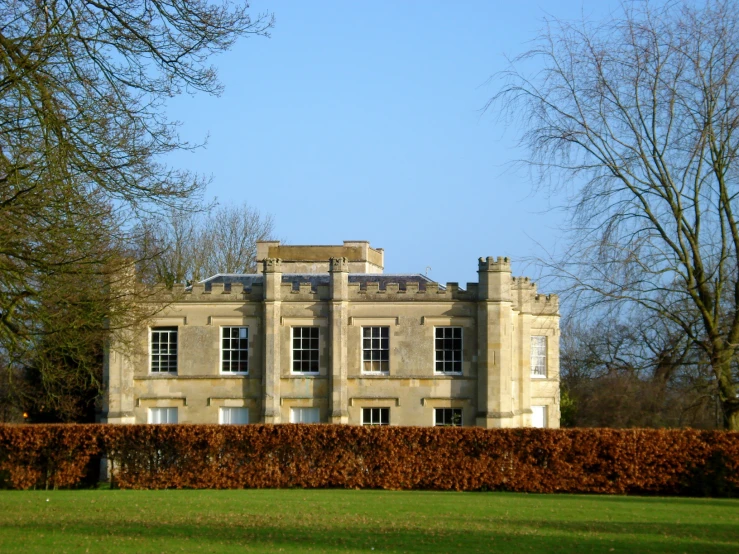 there is a large house that is built by the side of a hedge